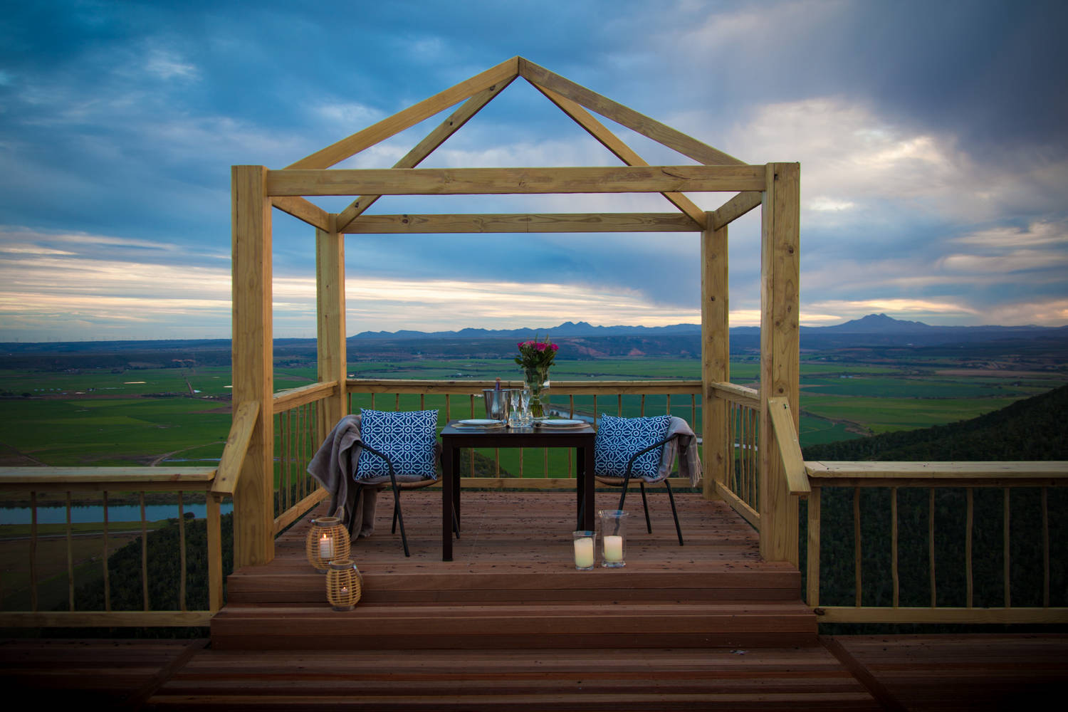Couple enjoying a sundowner on Intle's deck with sweeping Eastern Cape views